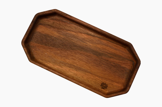A rectangular walnut wooden tray with a smooth finish and a small tree branding mark on the bottom right corner.