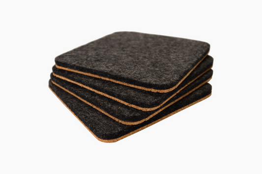 Stack of 4 charcoal wool and cork coasters on a white background.