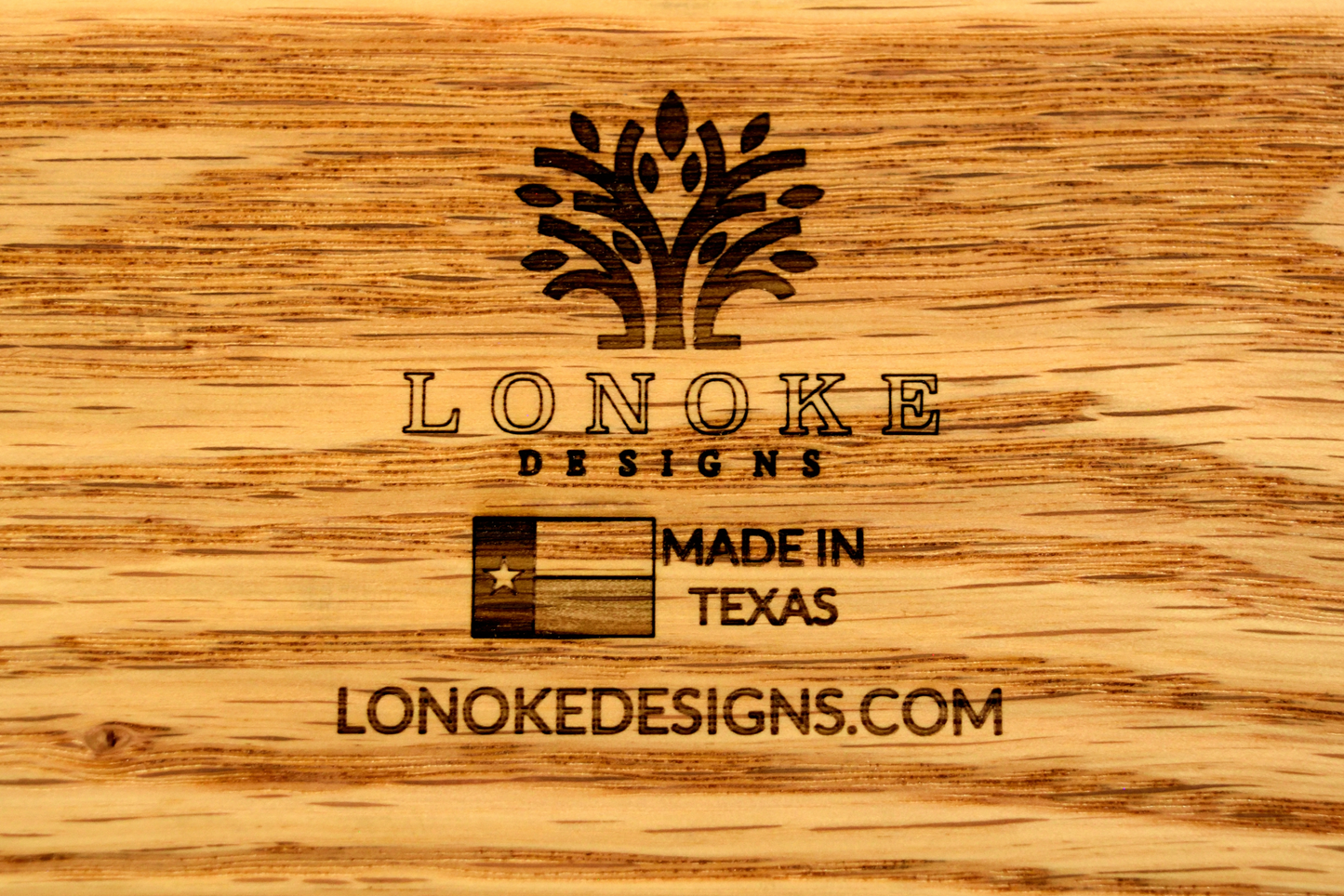 Lonoke Designs Logo with tree lonokedesigns.com and Texas flag.