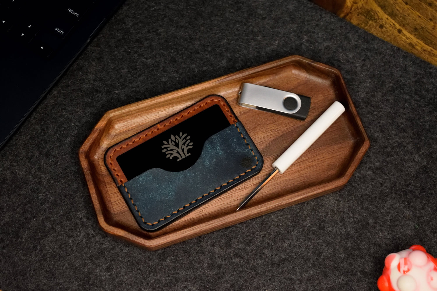 Handmade leather Micro Wallet resting in a walnut organizer tray by Lonoke Designs, crafted in Texas.