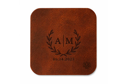 A Cognac brown veg-tanned leather square coaster with rounded corners, featuring a small Lonoke Designs logo in the bottom right corner, set against a plain white background. Featuring an example of a monogram custom laser engraving.