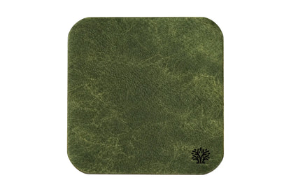 An Emerald green veg-tanned leather square coaster with rounded corners, featuring a small Lonoke Designs logo in the bottom right corner, set against a plain white background.