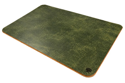 An Emerald green, veg-tanned leather rectangular mouse pad with rounded corners, angled to highlight the cork bottom, featuring a small Lonoke Designs logo in the bottom-right corner, set against a plain white background.