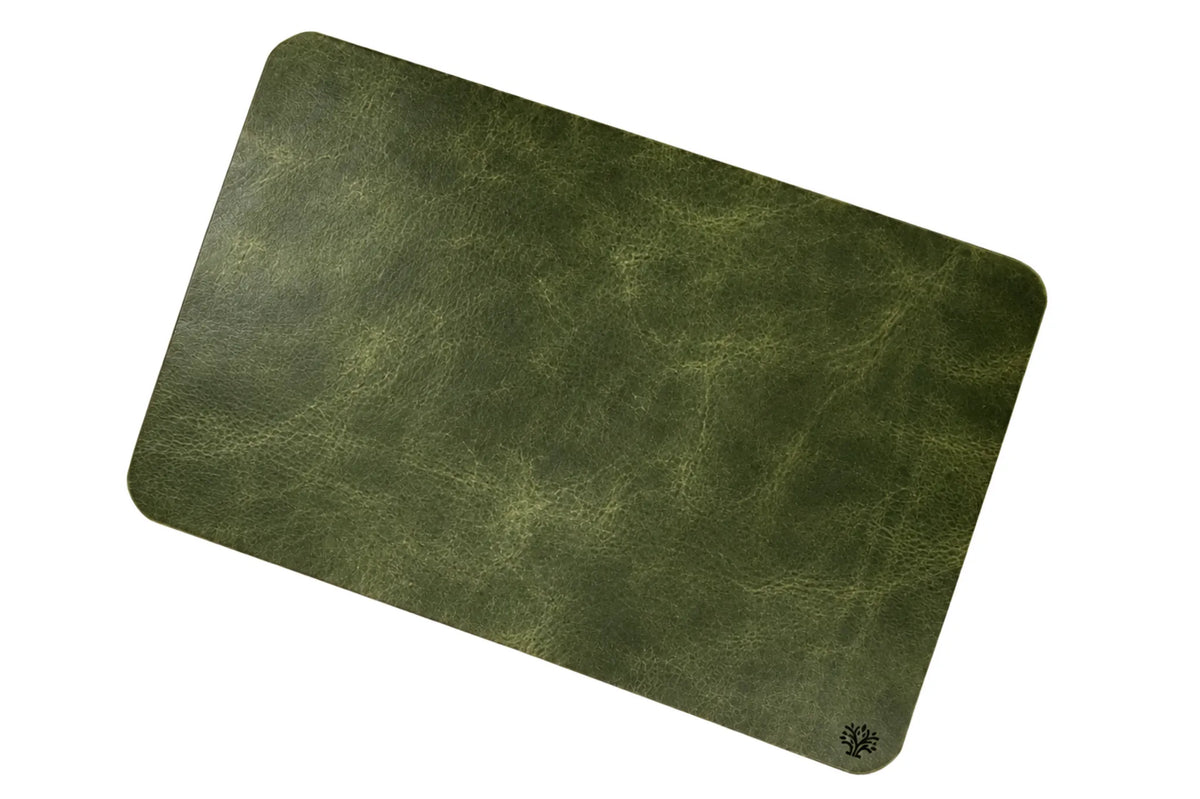 An Emerald green, veg-tanned leather rectangular mouse pad with rounded corners, featuring a small Lonoke Designs logo in the bottom right corner, set against a plain white background.