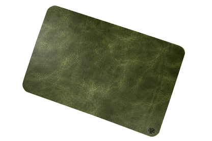 An Emerald green, veg-tanned leather rectangular mouse pad with rounded corners, featuring a small Lonoke Designs logo in the bottom right corner, set against a plain white background.