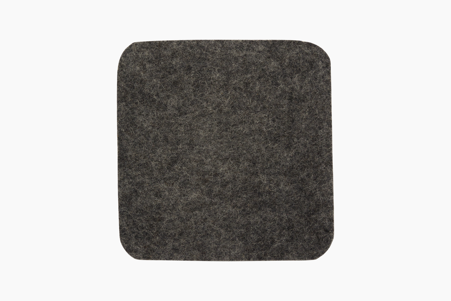 Square Shadow gray wool felt coasters with cork backing placed on a white surface.