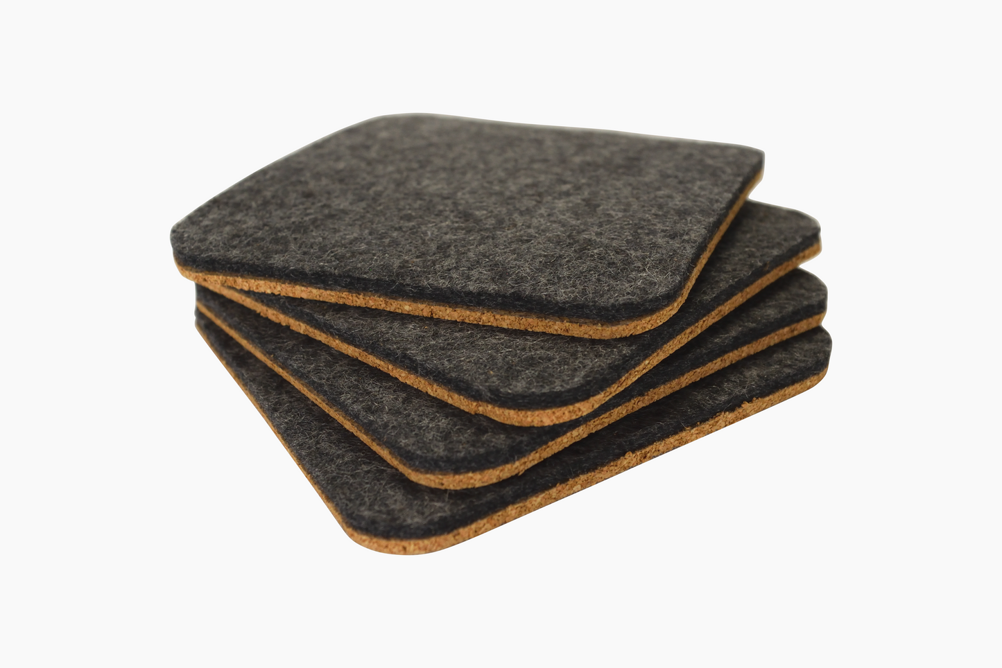 A set of square Shadow gray wool felt coasters with cork backing placed on a white surface.
