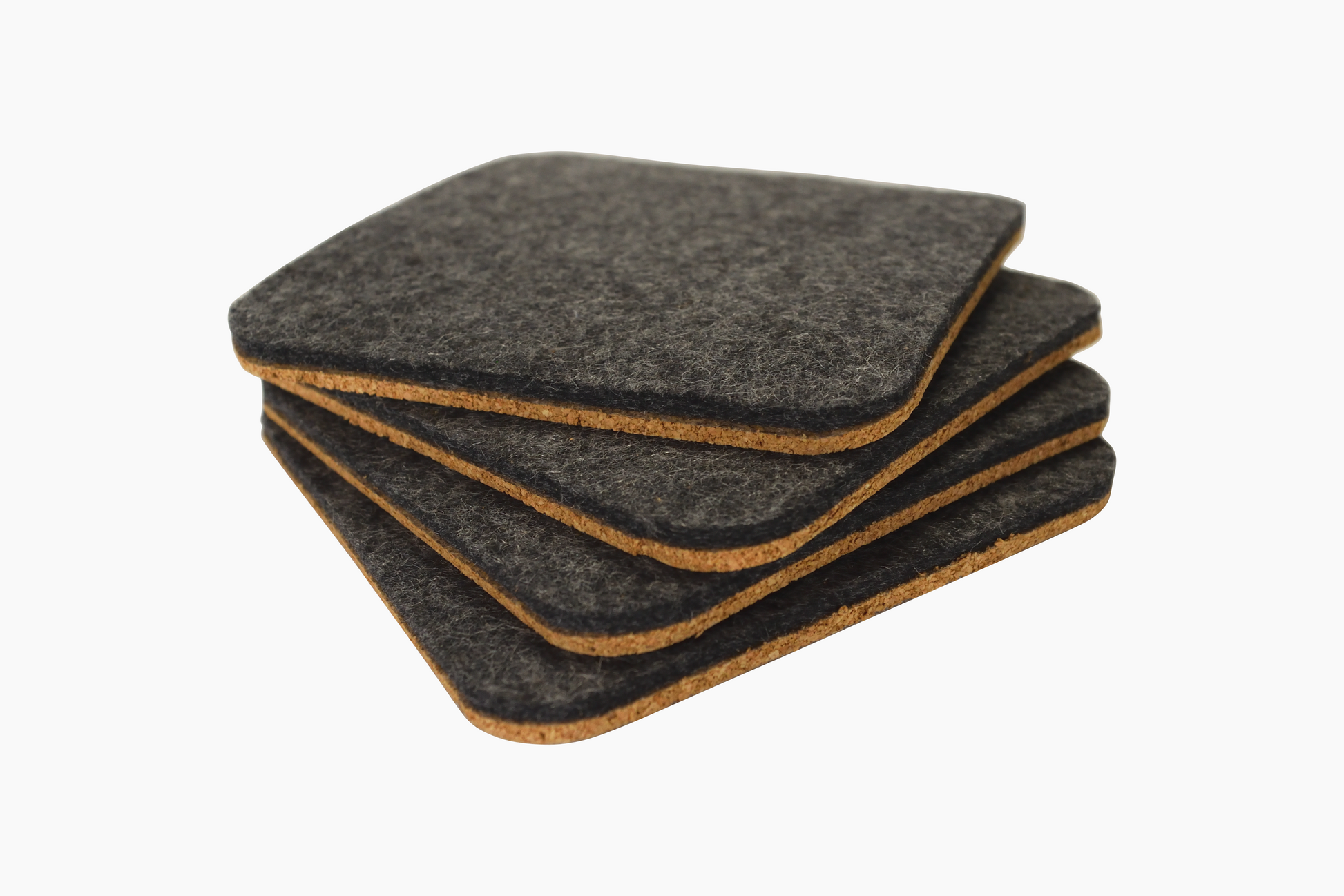 A set of square Shadow gray wool felt coasters with cork backing placed on a white surface.