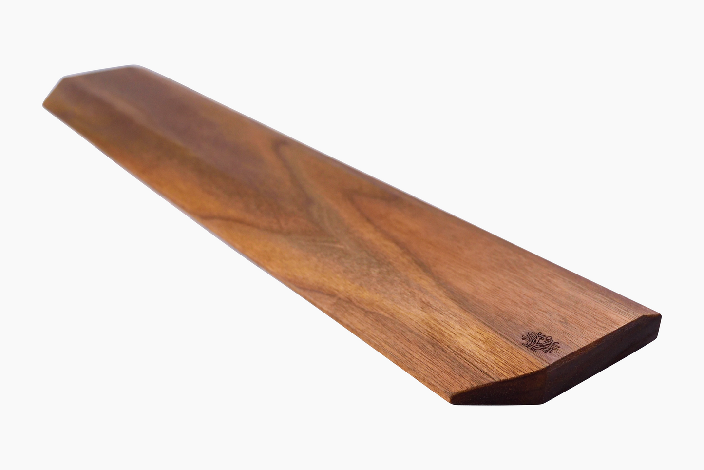 A rectangular walnut wrist rest with a smooth finish on a white background.