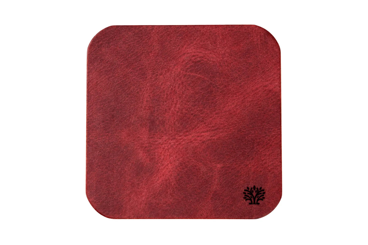 A Ridglea Rouge red veg-tanned leather square coaster with rounded corners, featuring a small Lonoke Designs logo in the bottom right corner, set against a plain white background.