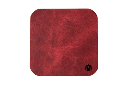 A Ridglea Rouge red veg-tanned leather square coaster with rounded corners, featuring a small Lonoke Designs logo in the bottom right corner, set against a plain white background.