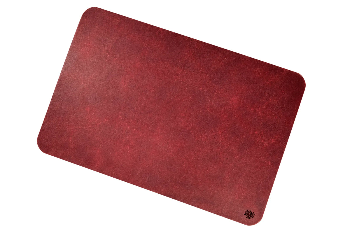 A Ridglea Rouge red, veg-tanned leather rectangular mouse pad with rounded corners, featuring a small Lonoke Designs logo in the bottom right corner, set against a plain white background.