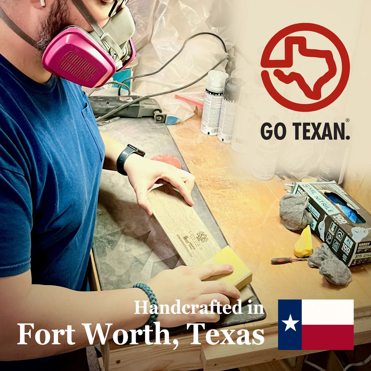A man wearing a pink respirator mask works at a wooden table in the Lonoke Designs workshop, holding a sanding block. The scene includes GO TEXAN logo and Texas flag with text that states Hancrafted in Fort Worth, Texas.