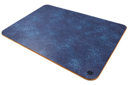 A Sapphire blue, veg-tanned leather rectangular mouse pad with rounded corners, angled to highlight the cork bottom, featuring a small Lonoke Designs logo in the bottom-right corner, set against a plain white background.