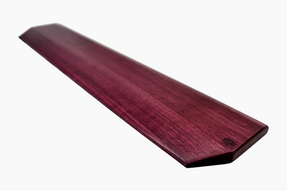 A Lonoke Designs Purpleheart wood mechanical keyboard wrist rest shown from a side angle on a solid white background.