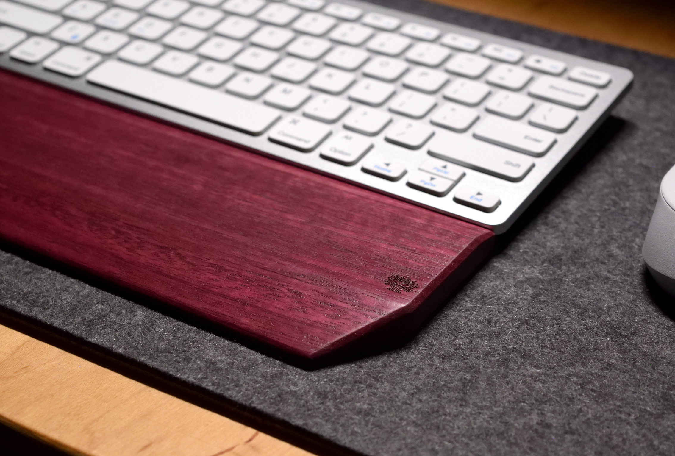 White keyboard on a wooden keyboard tray with a gray surface