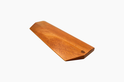 Side angle of handmade Lonoke Designs African Mahogany hardwood wrist rest by Lonoke Designs, showing smooth finish and natural wood grain.